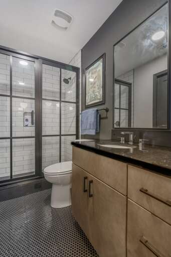 A sophisticated bathroom equipped with a large glass shower, contemporary vanity, and classic subway tiling, offering a blend of modern amenities and timeless style. A sophisticated bathroom equipped with a large glass shower, contemporary vanity, and classic subway tiling, offering a blend of modern amenities and timeless style.