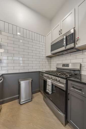 Perfect for the urban chef, this corner of the kitchen utilizes space efficiently with top-of-the-line appliances and ample cabinet storage, ensuring everything you need is within reach. Perfect for the urban chef, this corner of the kitchen utilizes space efficiently with top-of-the-line appliances and ample cabinet storage, ensuring everything you need is within reach.