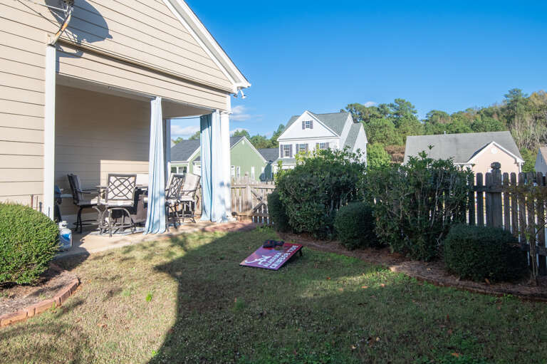 Spacious backyard with a covered patio, perfect for outdoor relaxation and activities.  Spacious backyard with a covered patio, perfect for outdoor relaxation and activities.
