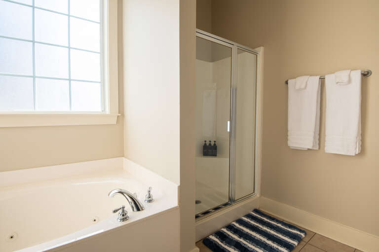 Modern bathroom with a large tub and shower, ideal for relaxation. Modern bathroom with a large tub and shower, ideal for relaxation.