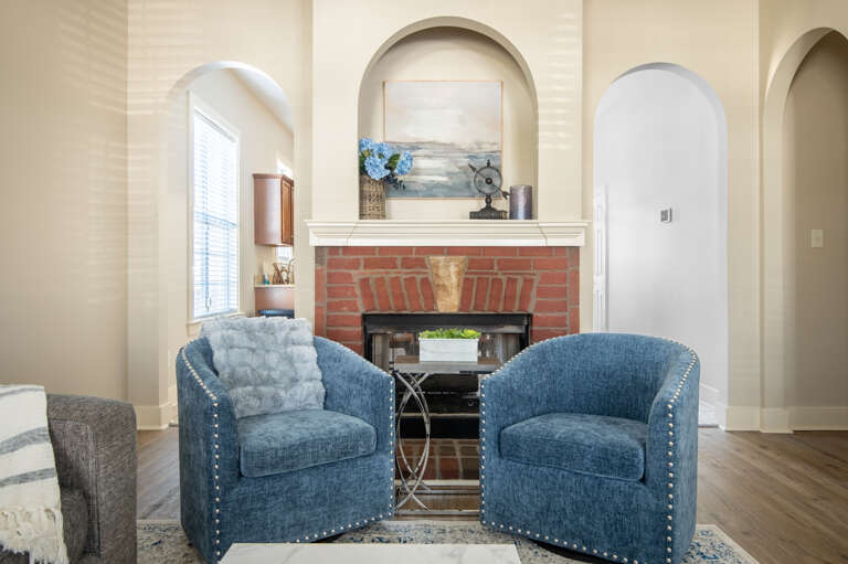 Cozy sitting area by the fireplace, perfect for unwinding with a good book or coffee. Cozy sitting area by the fireplace, perfect for unwinding with a good book or coffee.