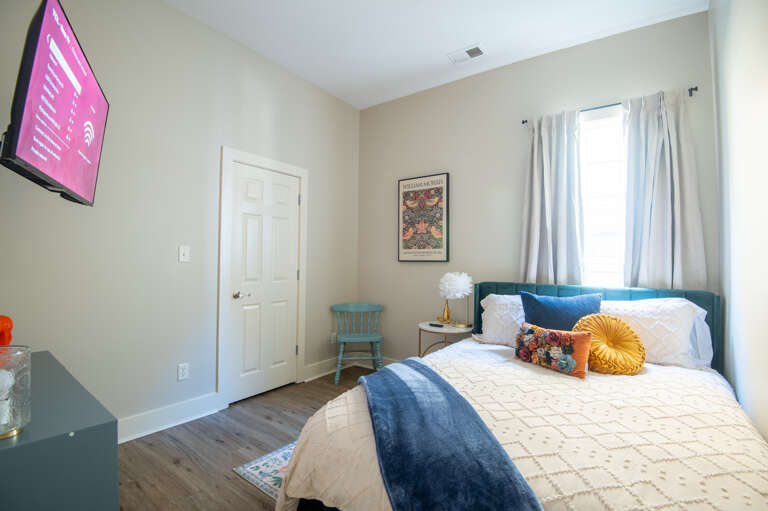 Relax and unwind in a comfortable bedroom with a TV and calming decor. Relax and unwind in a comfortable bedroom with a TV and calming decor.