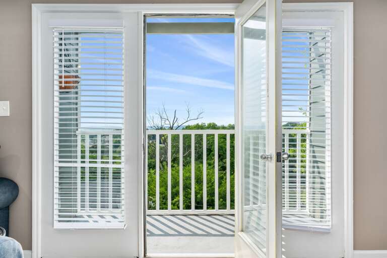 Sliding glass doors offering natural light and access to the outdoor patio Sliding glass doors offering natural light and access to the outdoor patio