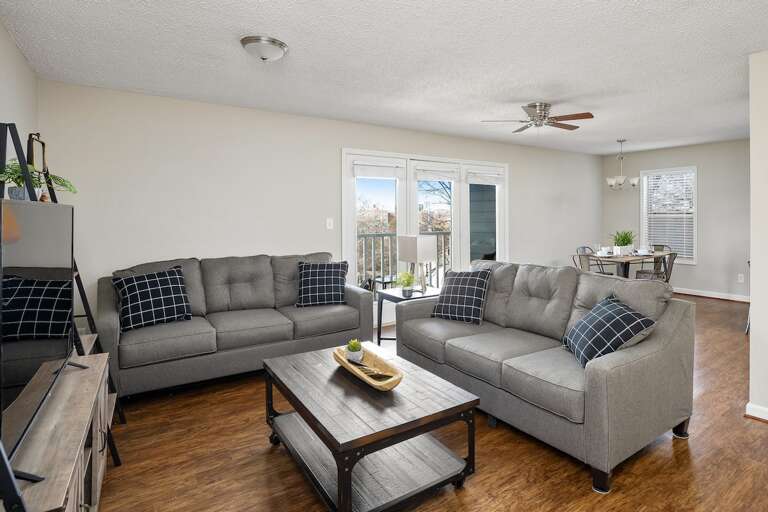 Large living space with a sectional sofa, perfect for family gatherings or movie nights Large living space with a sectional sofa, perfect for family gatherings or movie nights