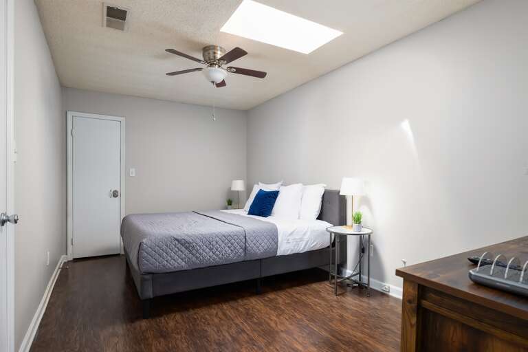 Cozy bedroom with a king-size bed and a skylight for added natural light Cozy bedroom with a king-size bed and a skylight for added natural light