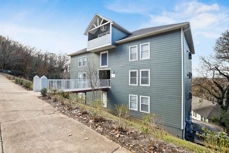 Step into serenity at Hilltop Hideaway! Angled exterior view of the building, showing its modern design and well-maintained entrance.