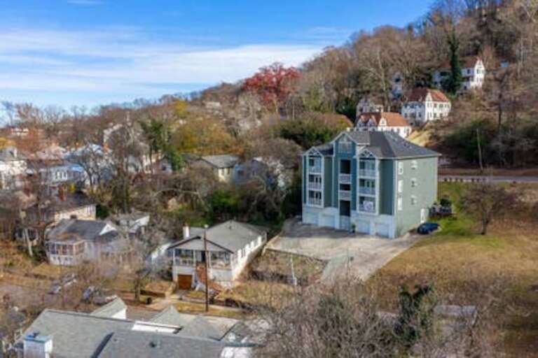Aerial view of the surrounding neighborhood, highlighting the peaceful and charming area.