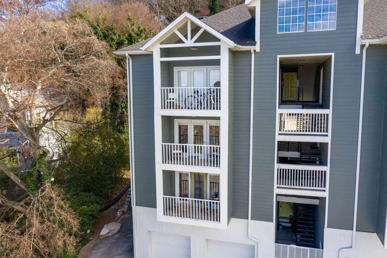 Rear view of the property showcasing private balconies and a contemporary multi-unit design.