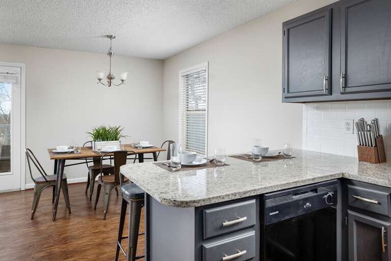Dining area with a modern table and chairs, ready for group meals or casual dining.