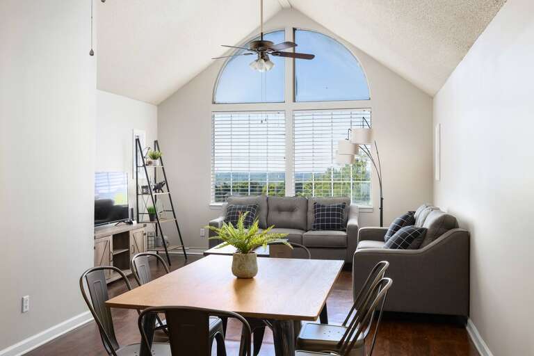 Bright dining space with arched windows, natural light, and seating for group meals.