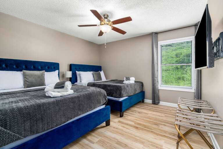 Bright and modern bedroom with blue accents and comfortable bedding for a restful stay.