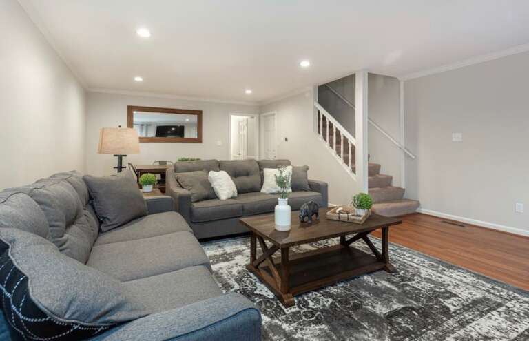 Modern living room with a comfortable sectional, flat-screen TV, and open design perfect for relaxation or entertaining. Modern living room with a comfortable sectional, flat-screen TV, and open design perfect for relaxation or entertaining.