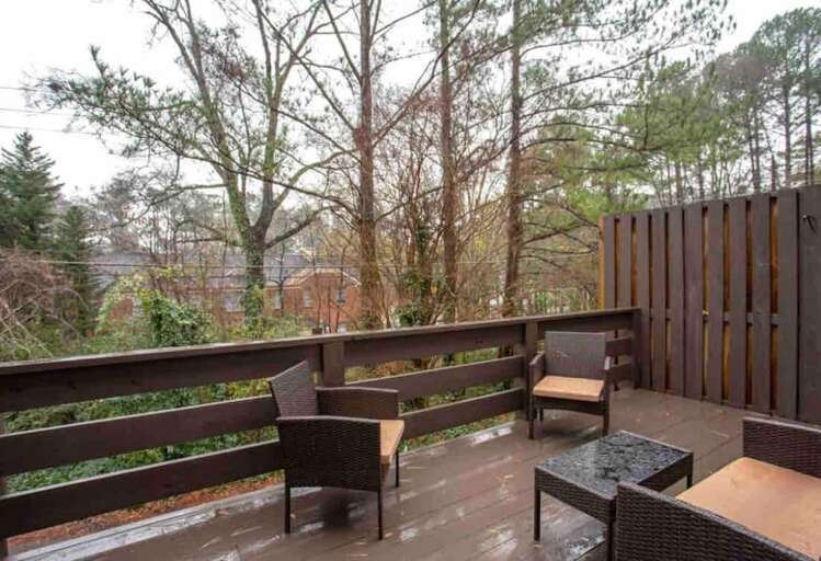 Private outdoor deck with seating and serene views of the surrounding greenery, perfect for relaxation. Private outdoor deck with seating and serene views of the surrounding greenery, perfect for relaxation.