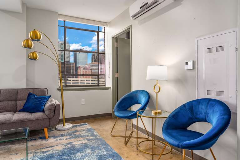 Bright seating area with bold accents, ideal for relaxation or casual conversations.