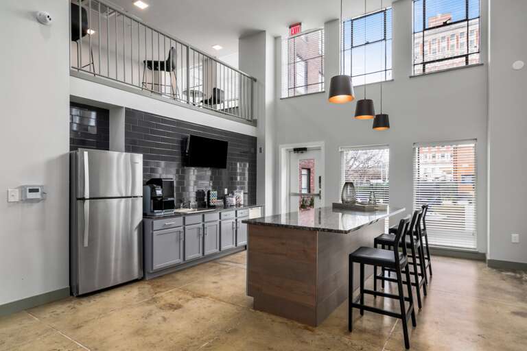 Open-concept common kitchen and dining area with modern appliances and ample space.