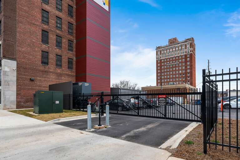 Gated parking lot offering security and convenience for all guests using key fob.