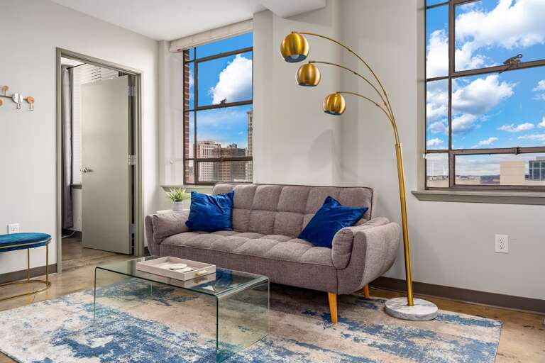 Comfortable living space with large windows offering stunning views of the city skyline.