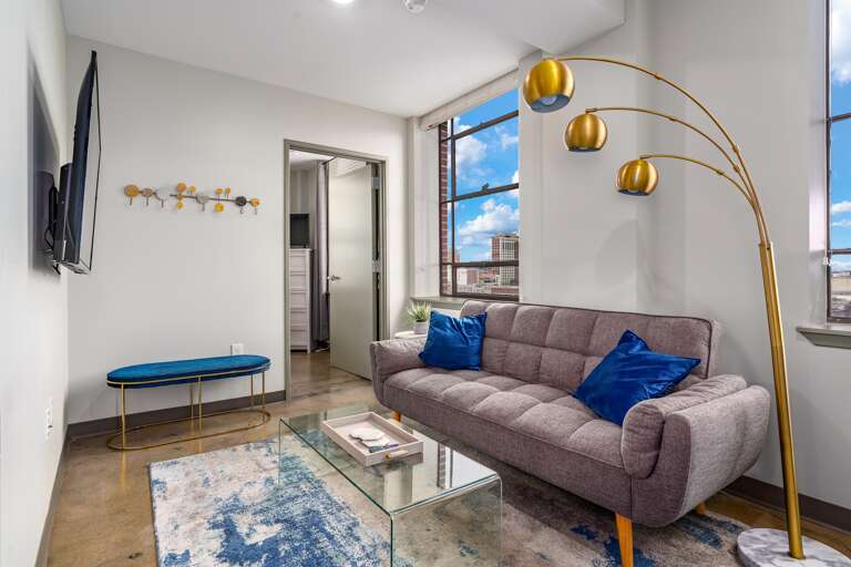 Bright living area with bold decor, large windows, and a welcoming seating arrangement.