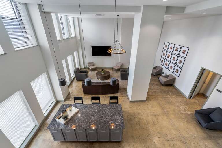 Open common lounge with abundant natural light, elegant furniture, and a relaxing ambiance.