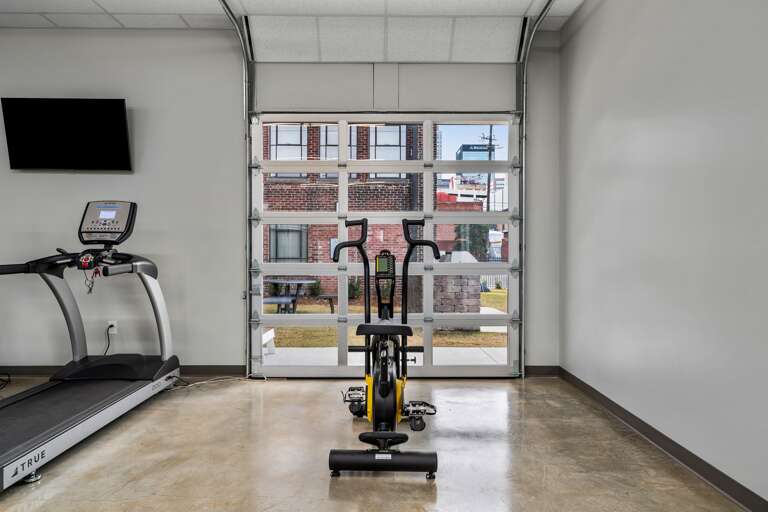 Contemporary fitness facility designed with a selection of machines and weights for a comprehensive workout. 