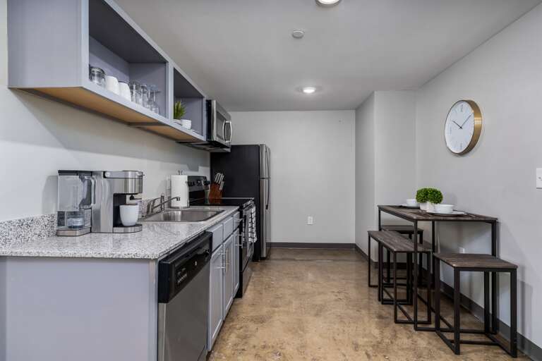 Spacious kitchen featuring modern design and convenient amenities for your stay.