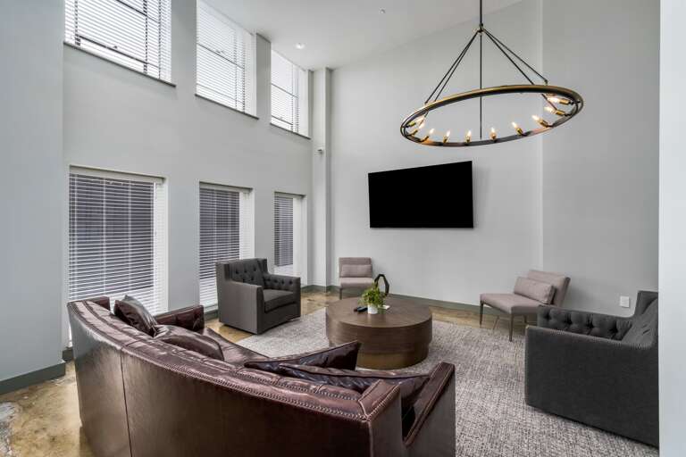 Common lounge area with stunning city views, offering a perfect space to relax or socialize.