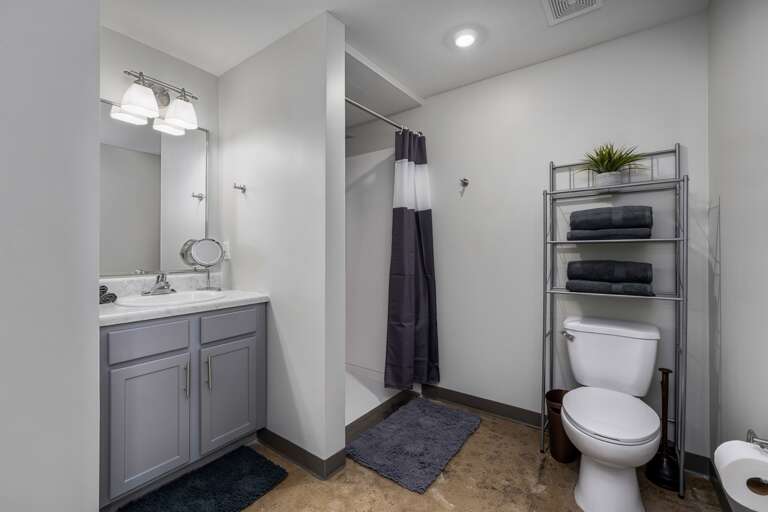 Modern bathroom with sleek finishes, fresh towels, and a spacious walk-in shower.