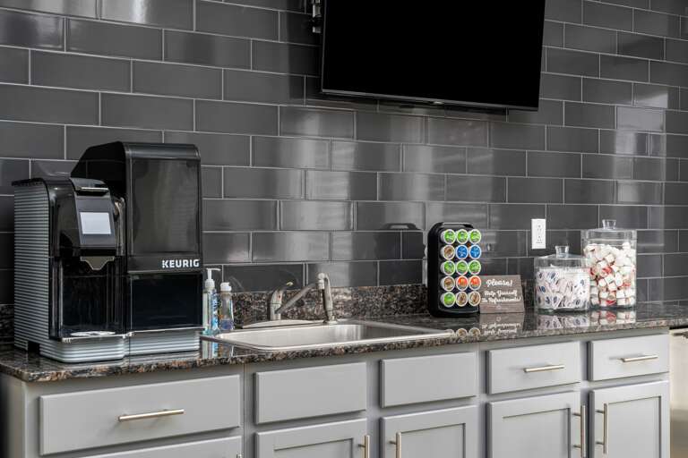 Fully equipped coffee bar in the common area, offering a perfect spot to grab a cup. Fully equipped coffee bar in the common area, offering a perfect spot to grab a cup.