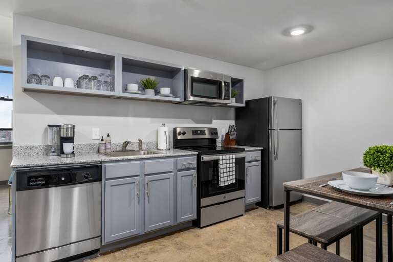 Fully equipped kitchen with stainless steel appliances, sleek finishes, and ample counter space. Fully equipped kitchen with stainless steel appliances, sleek finishes, and ample counter space.
