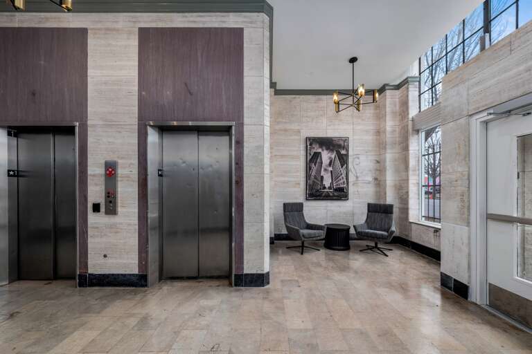 Secure elevator lobby with modern decor and key fob access for added safety. Secure elevator lobby with modern decor and key fob access for added safety.