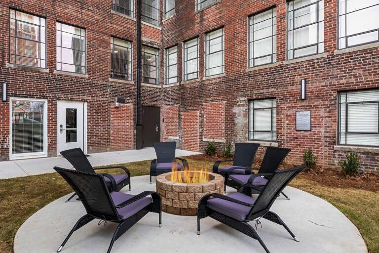 Common outdoor patio area with chic furniture and a welcoming atmosphere for socializing or unwinding. Common outdoor patio area with chic furniture and a welcoming atmosphere for socializing or unwinding.
