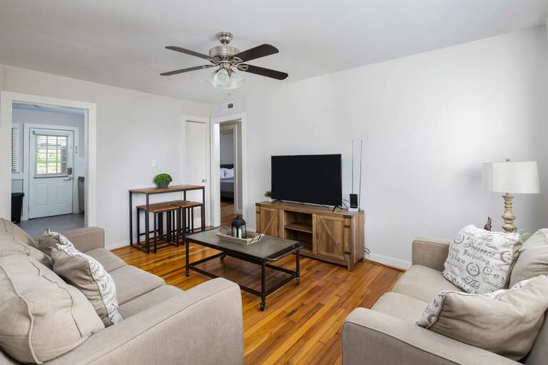 Open-concept living area featuring plush seating, a sleek coffee table, and a calming neutral palette. A perfect blend of comfort and style.