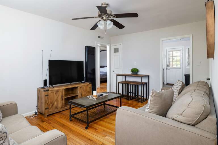 Another angle of the living room, showcasing the thoughtful layout and ample seating for relaxation.