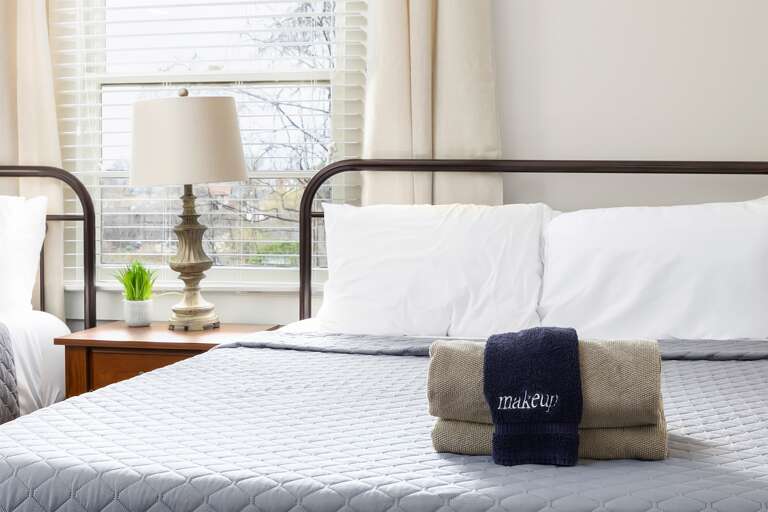 The guest bedroom in Unit C features two comfortable queen beds with luxurious linens, bedside lighting, and a serene atmosphere.