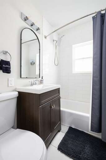 Unit C’s modern bathroom features a combination tub/shower, a sleek vanity, and fresh towels for your convenience.