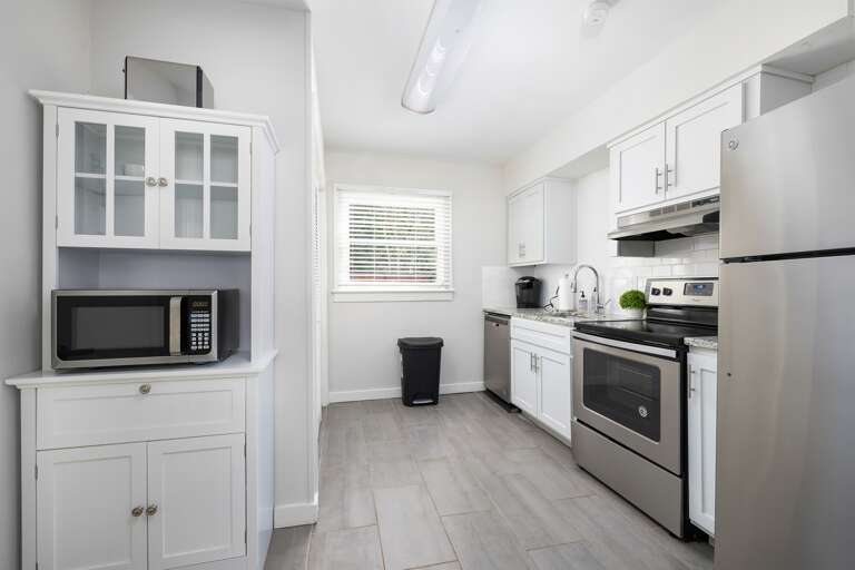 The open-concept design of the living and kitchen areas creates a welcoming atmosphere for guests to relax and socialize.