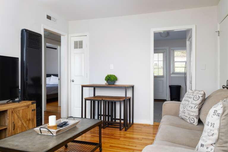 The open-concept layout allows easy flow between the living room, dining area, and kitchen, perfect for gathering and entertaining.