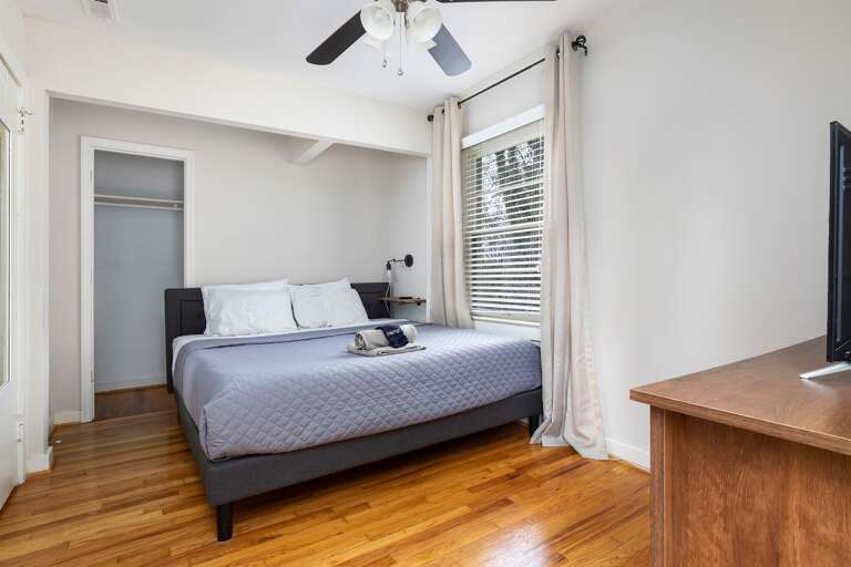 A serene and stylish master bedroom with a king bed and closet space to make you feel right at home.