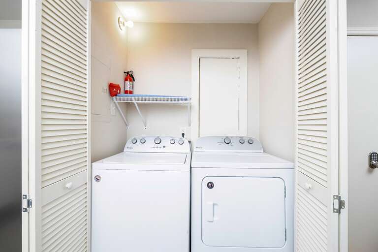 In-unit laundry with a full-size washer and dryer, conveniently tucked behind louvered doors. Detergent is provided for your stay. In-unit laundry with a full-size washer and dryer, conveniently tucked behind louvered doors. Detergent is provided for your stay.