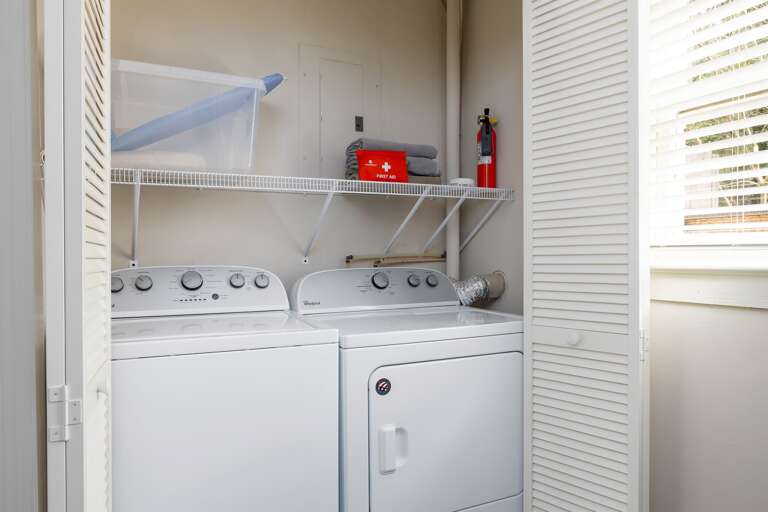 Convenient in-unit laundry with a washer and dryer, neatly hidden behind louvered doors for easy access. Convenient in-unit laundry with a washer and dryer, neatly hidden behind louvered doors for easy access.