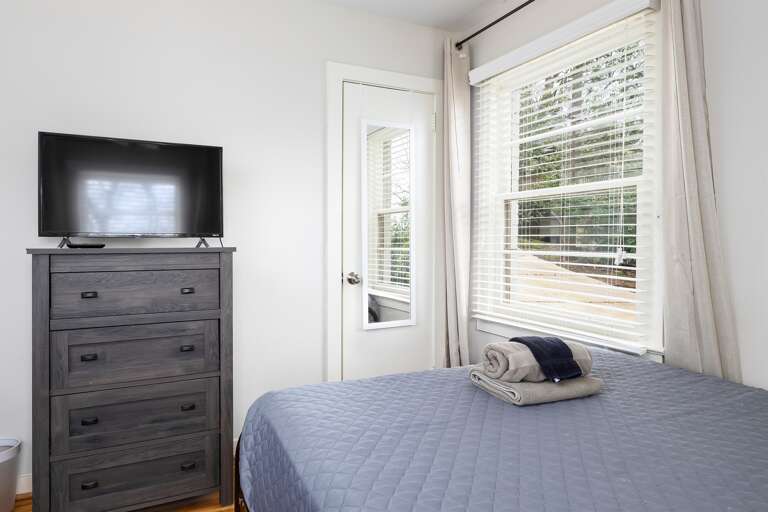 Alternate angle of the double-queen bedroom, highlighting the smart TV and dresser for added convenience. Alternate angle of the double-queen bedroom, highlighting the smart TV and dresser for added convenience.