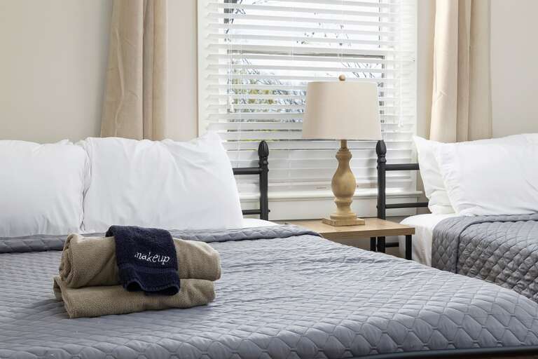 Double-queen bedroom with plenty of space, clean lines, and thoughtful decor to ensure a restful stay. Double-queen bedroom with plenty of space, clean lines, and thoughtful decor to ensure a restful stay.