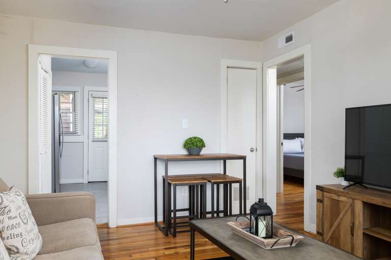 A welcoming view of the living room leading to the bedrooms. Thoughtful decor and ample lighting make this space feel like home. A welcoming view of the living room leading to the bedrooms. Thoughtful decor and ample lighting make this space feel like home.