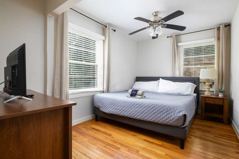 Master bedroom featuring a king-size bed with cozy bedding, a bedside lamp, and stylish decor. Master bedroom featuring a king-size bed with cozy bedding, a bedside lamp, and stylish decor.