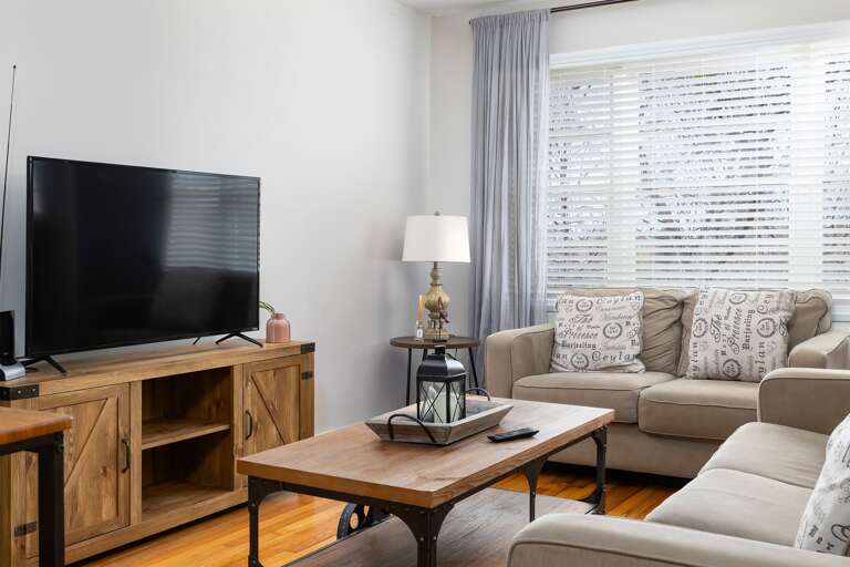 Another angle of the living room, highlighting the modern furniture and charming decorative touches. Another angle of the living room, highlighting the modern furniture and charming decorative touches.