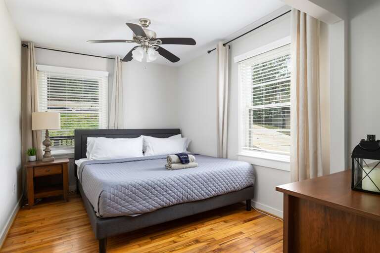 Spacious master bedroom with a luxurious king bed, elegant decor, and crisp, clean linens. Spacious master bedroom with a luxurious king bed, elegant decor, and crisp, clean linens.