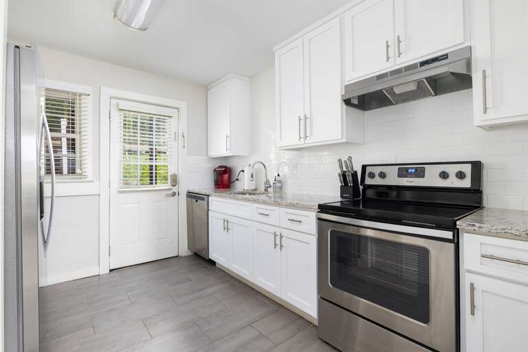 Modern kitchen with stainless steel appliances, white cabinetry, and granite countertops. Fully equipped for preparing your favorite meals. Modern kitchen with stainless steel appliances, white cabinetry, and granite countertops. Fully equipped for preparing your favorite meals.