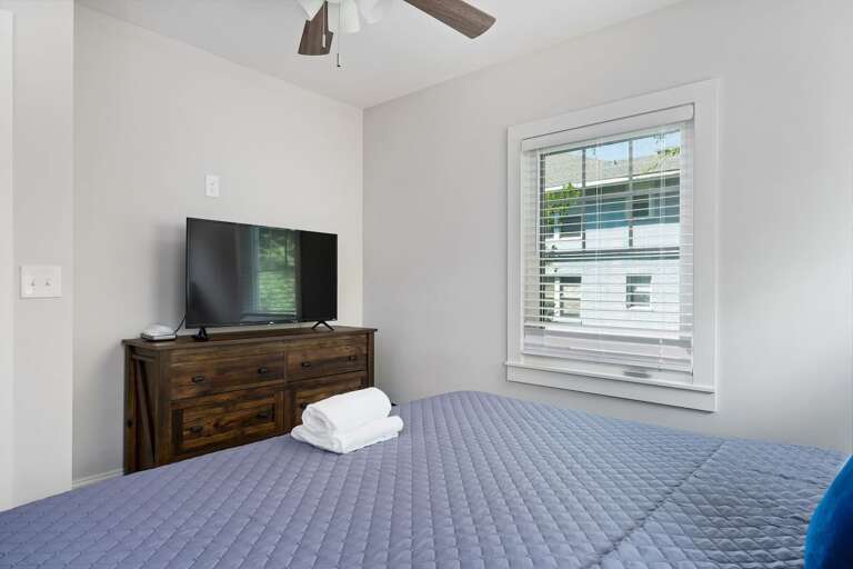 This cozy bedroom offers a large bed, soft lighting, and tranquil decor, ensuring a restful environment.