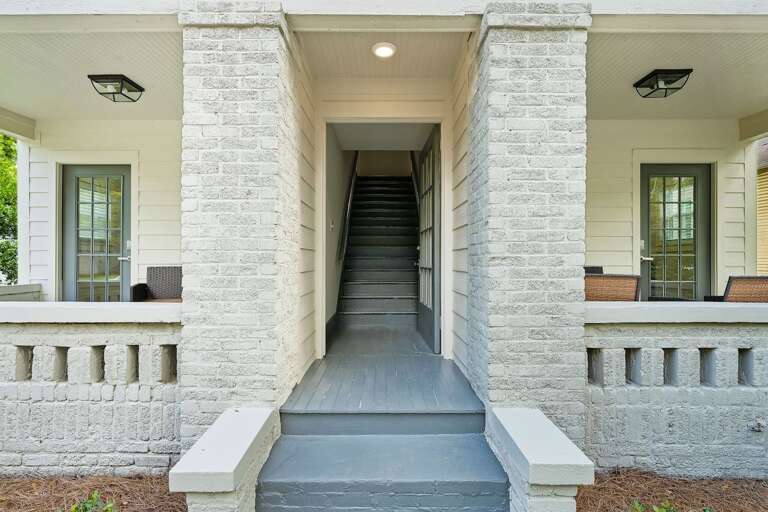 The grand hallway provides a striking entrance to the units, framed by classic architectural details that highlight the building's character.