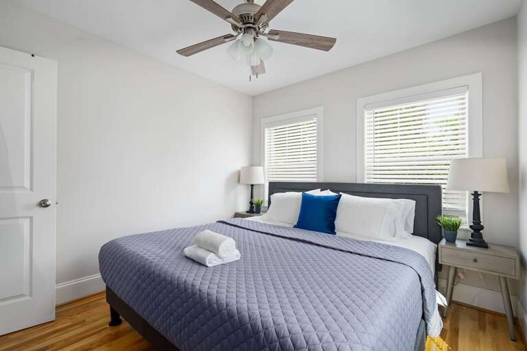 Serene and spacious, this bedroom boasts a comfortable king-sized bed and tasteful decor that ensures a restful night's sleep.